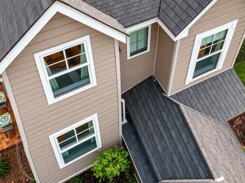 Illustration of house with new horizontal lap siding and white-trimmed windows.
